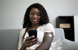 Woman using Continuous Glucose Remote Monitor